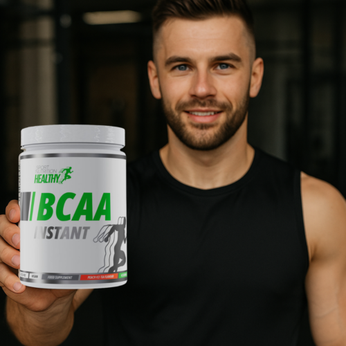 Close-up of a fit man presenting Healthy® BCAA Instant Orange in a gym setting.